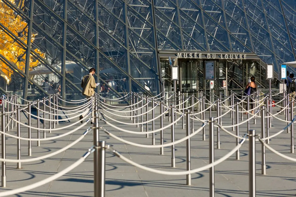Rows of chrome stanchions with belts forming a queue line