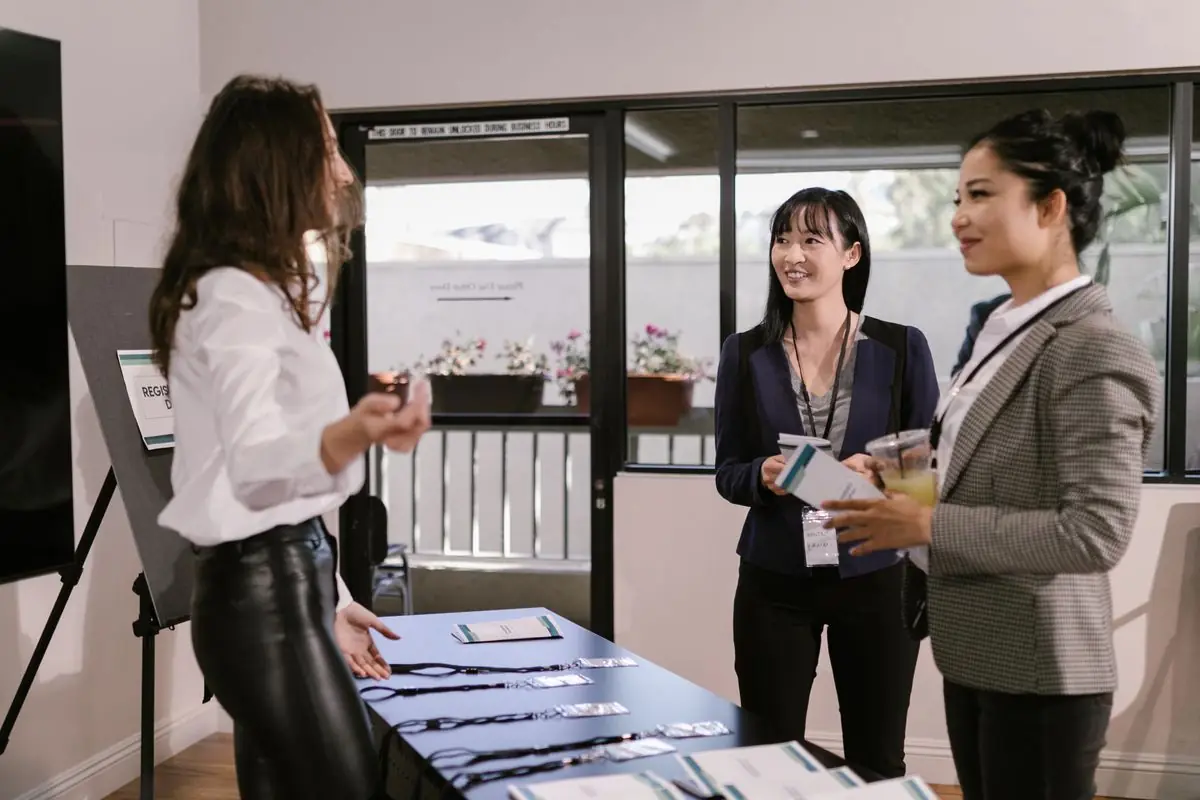 Guests talking at an event registration table