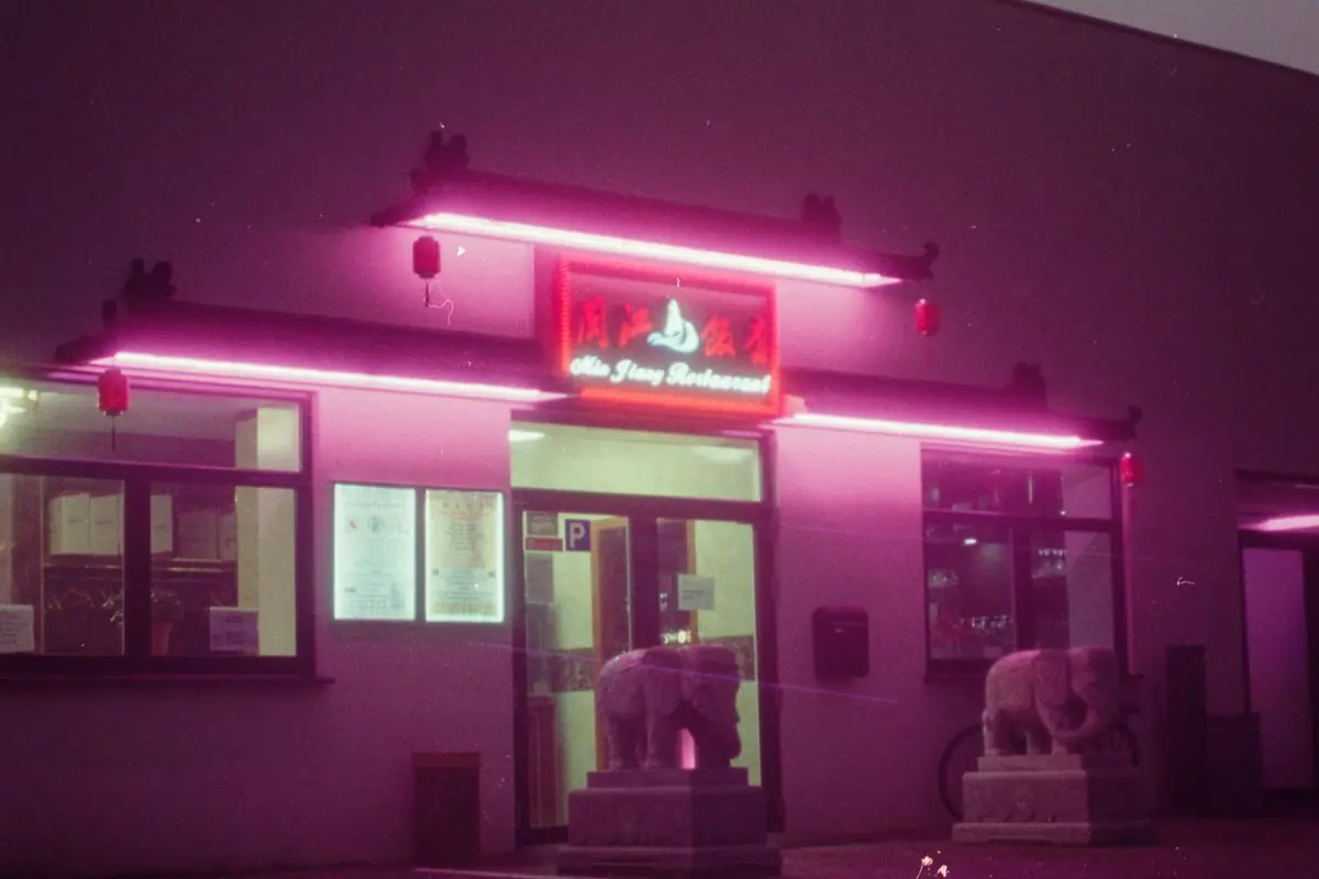 Neon-lit venue entrance at night