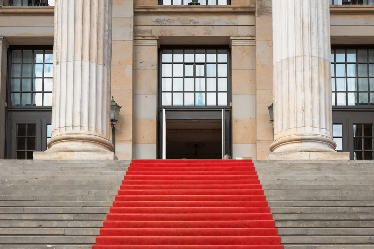 Red carpet leading up the steps of a building